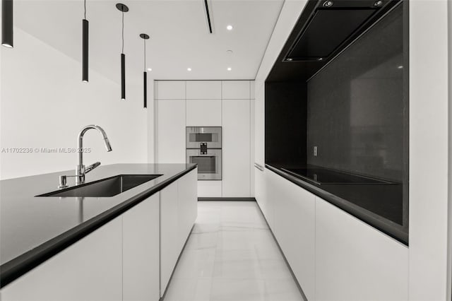 kitchen featuring a sink, white cabinetry, dark countertops, modern cabinets, and decorative light fixtures