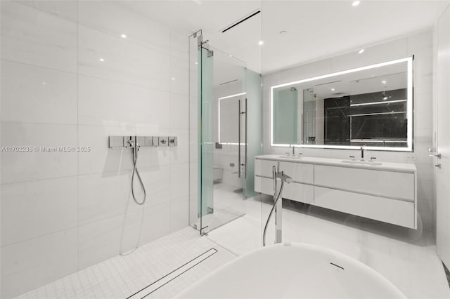 full bath featuring a sink, a shower stall, and double vanity