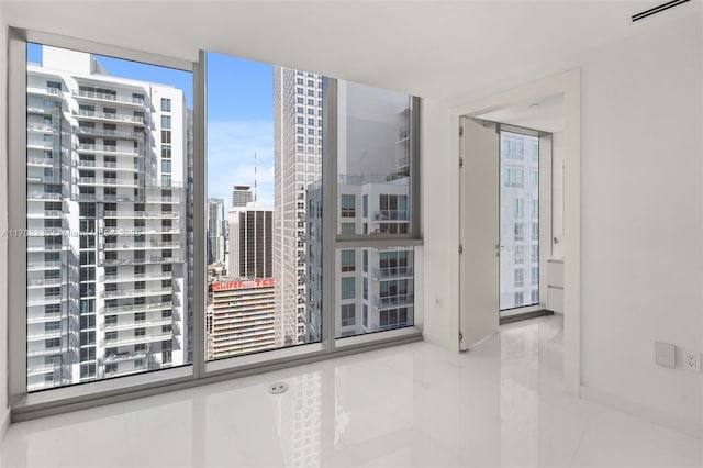 spare room featuring a view of city and visible vents