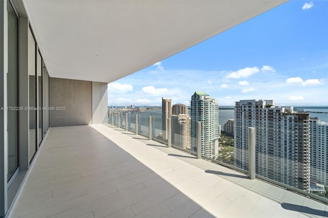 balcony with a view of city and a water view