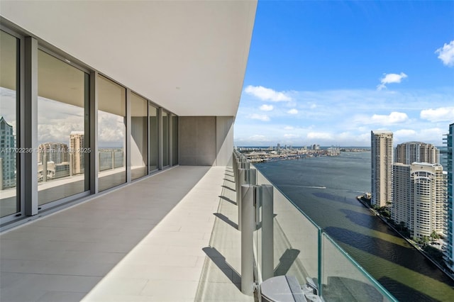 balcony with a water view and a city view