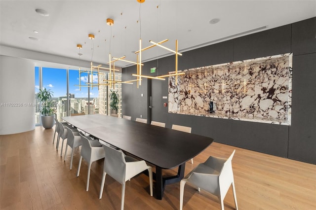 dining room featuring a view of city and wood finished floors