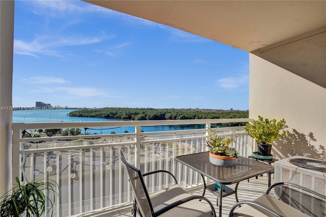 balcony with a water view and central AC unit