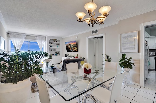 dining room featuring built in shelves, a textured ceiling, ornamental molding, and a notable chandelier