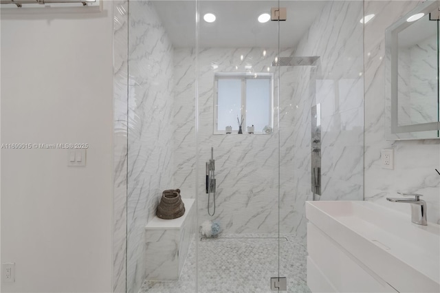 bathroom featuring walk in shower and vanity