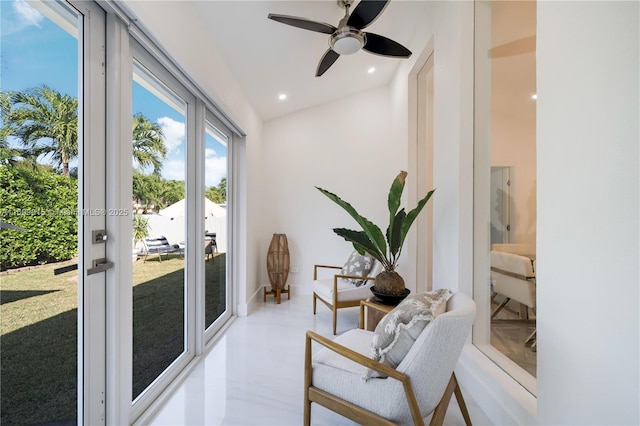 living area featuring ceiling fan