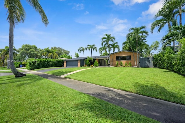 view of front facade featuring a garage and a front lawn