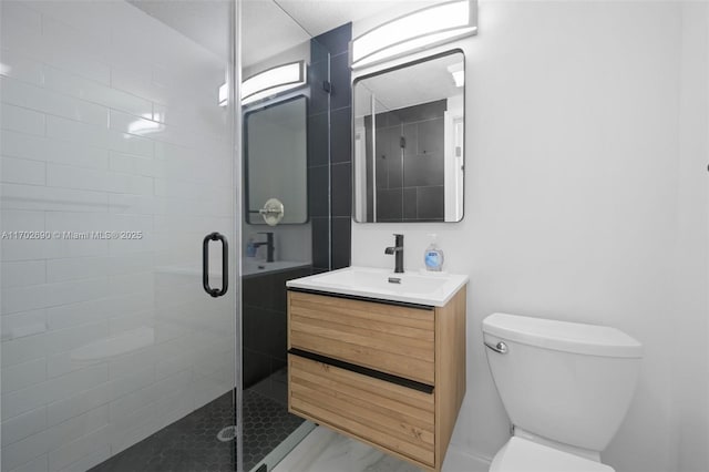 bathroom featuring vanity, toilet, and a shower with door