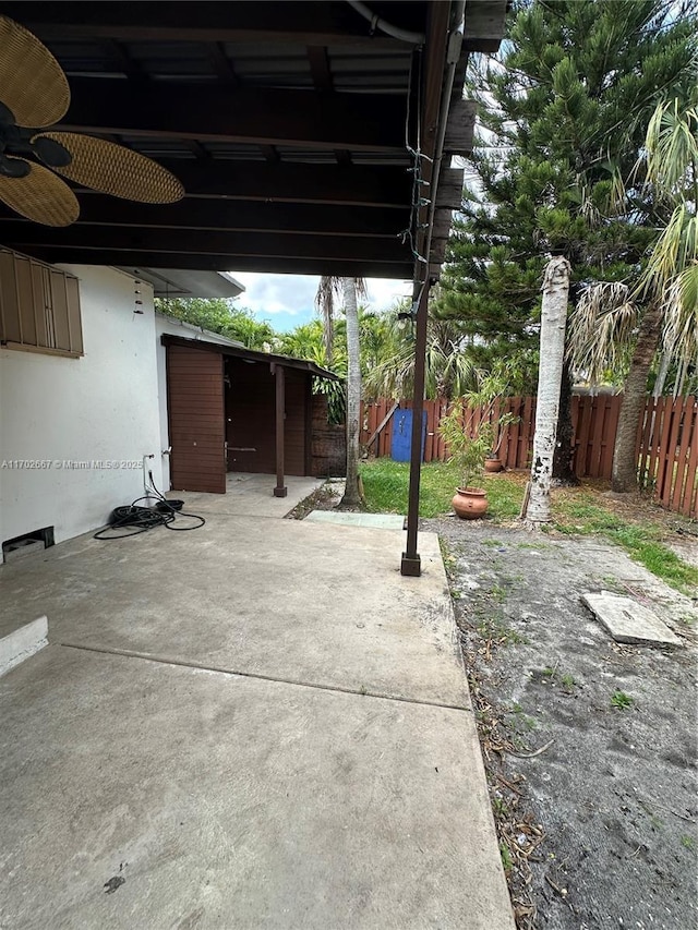 view of patio / terrace with fence and ceiling fan