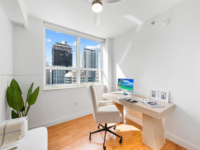 office area with ceiling fan and light hardwood / wood-style flooring