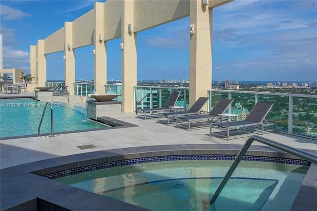 view of pool with a community hot tub and a patio area