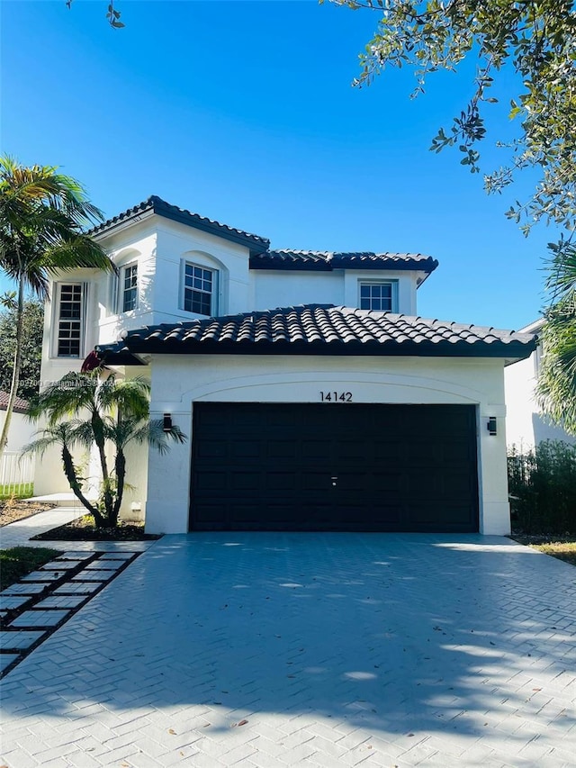 mediterranean / spanish-style house with a garage