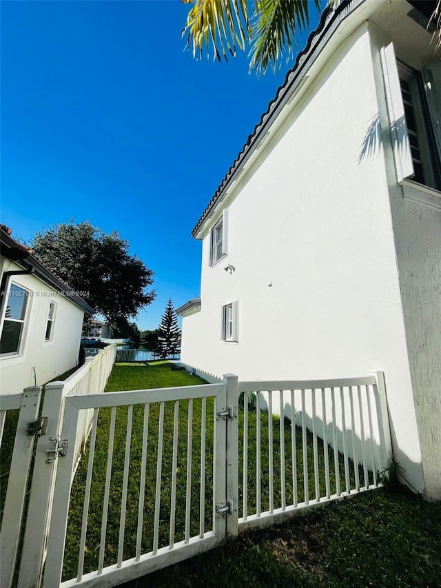 view of side of home featuring a yard