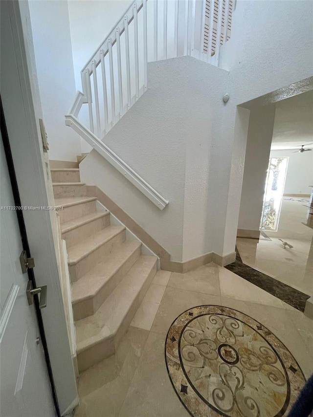 stairway featuring tile patterned flooring