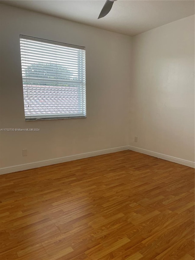 empty room featuring ceiling fan and light hardwood / wood-style flooring