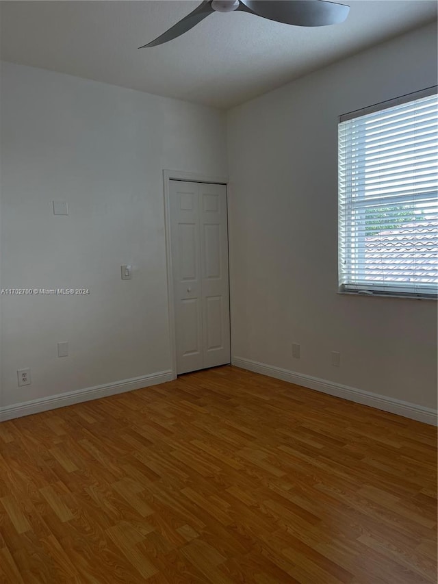 spare room featuring hardwood / wood-style floors and ceiling fan