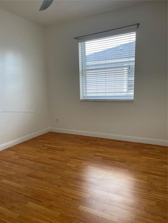 unfurnished room with ceiling fan and hardwood / wood-style floors