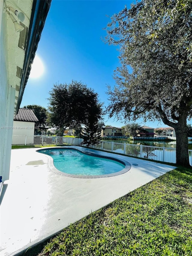 view of pool featuring a patio area and a water view