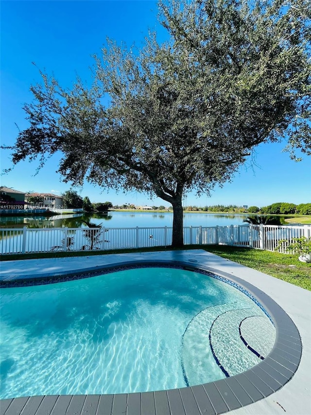 view of swimming pool with a water view