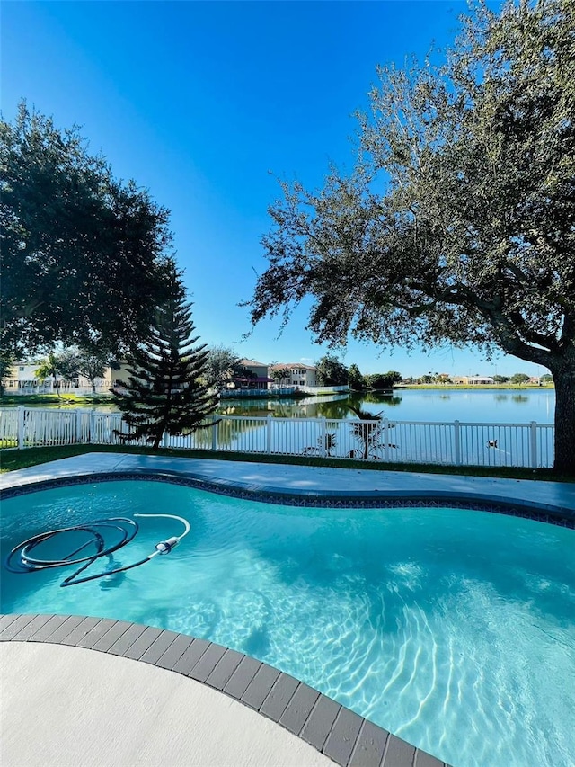 view of pool with a water view