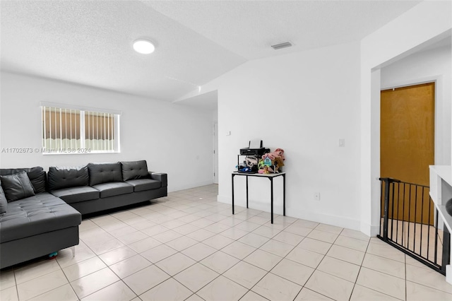 living room with light tile patterned floors and vaulted ceiling