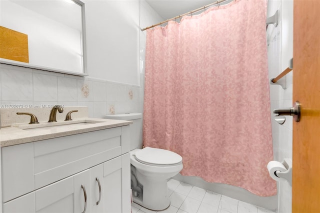 bathroom with vanity, tile walls, tile patterned flooring, toilet, and curtained shower