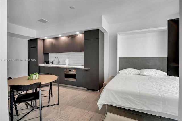 tiled bedroom featuring sink