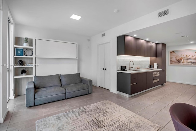 living room featuring light tile patterned floors and sink