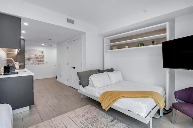 tiled bedroom featuring sink