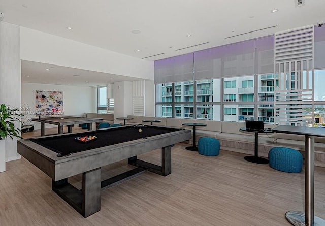 playroom featuring light hardwood / wood-style floors, a wealth of natural light, and pool table