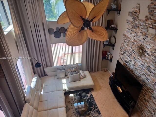 stairs with a wealth of natural light, hardwood / wood-style floors, and ceiling fan