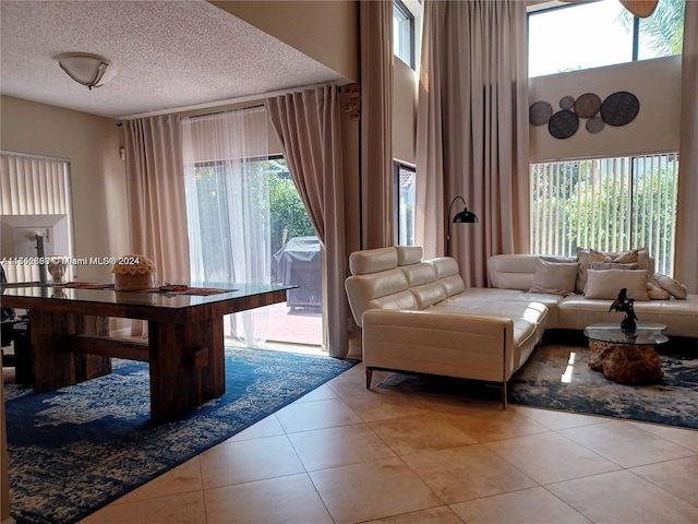 tiled living room featuring a healthy amount of sunlight and a textured ceiling