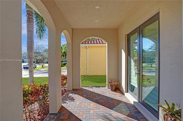 view of exterior entry featuring a patio area