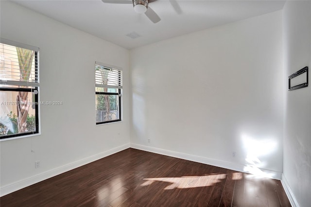 spare room featuring ceiling fan and dark wood-type flooring