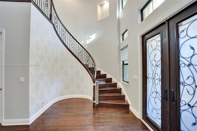 entrance foyer featuring hardwood / wood-style flooring, a high ceiling, and french doors