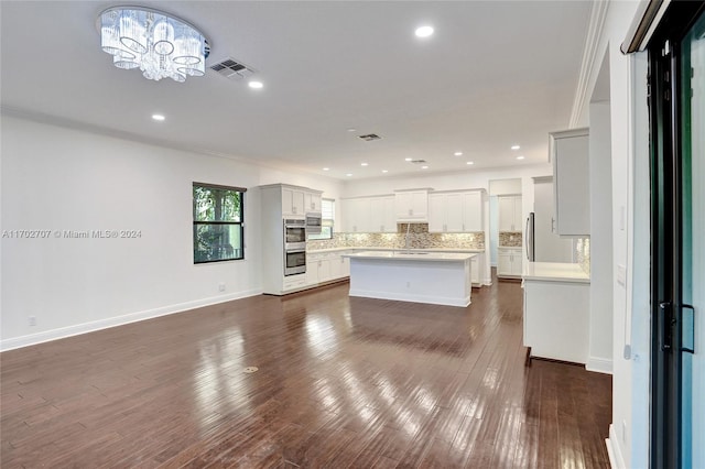 interior space featuring a chandelier, dark hardwood / wood-style flooring, and crown molding