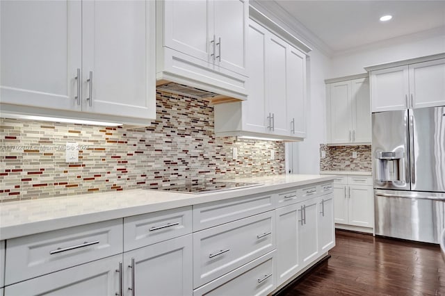 kitchen with stainless steel fridge, white cabinetry, dark wood-type flooring, and black electric cooktop