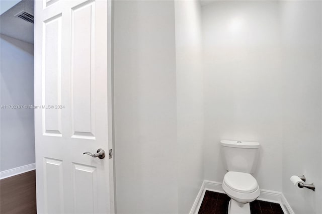 bathroom featuring wood-type flooring and toilet