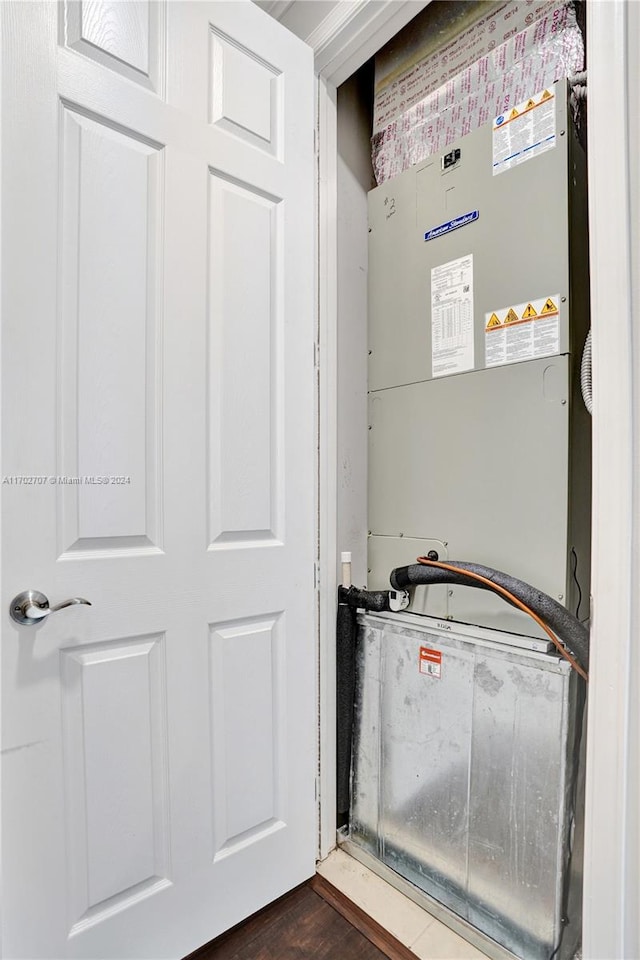 utility room featuring heating unit