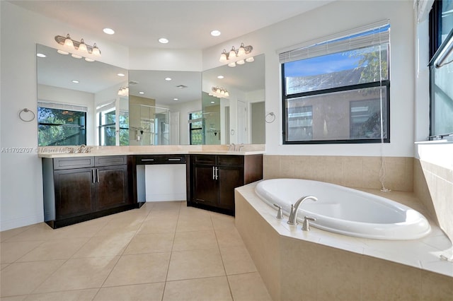 bathroom with vanity, tile patterned flooring, and plus walk in shower