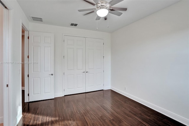 unfurnished bedroom with a closet, ceiling fan, and dark wood-type flooring