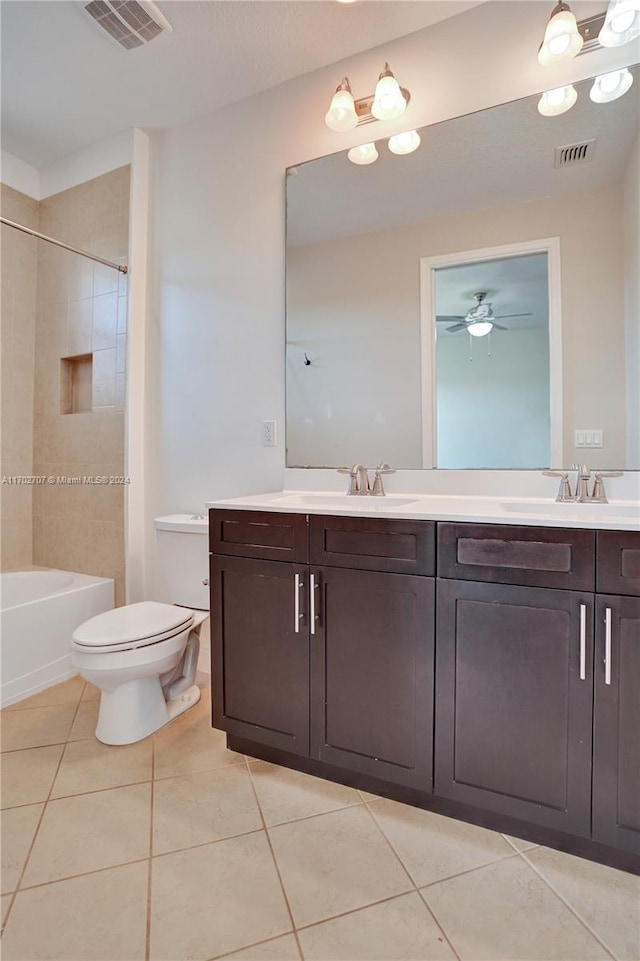 full bathroom with toilet, vanity, tile patterned floors, and tiled shower / bath