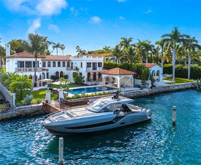 back of house featuring a yard and a water view