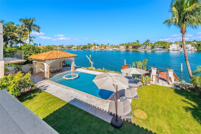 view of swimming pool with an in ground hot tub, a gazebo, an outdoor bar, a water view, and a lawn