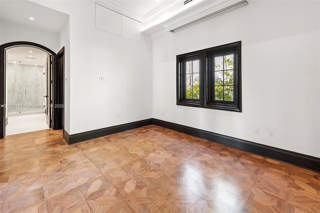 unfurnished room featuring light parquet flooring and ornamental molding