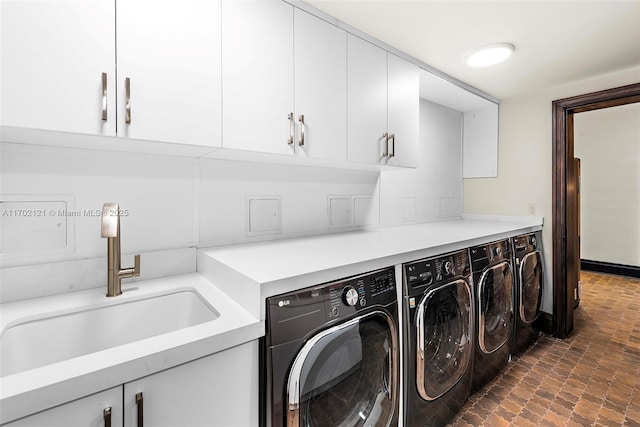 washroom featuring cabinets, separate washer and dryer, and sink