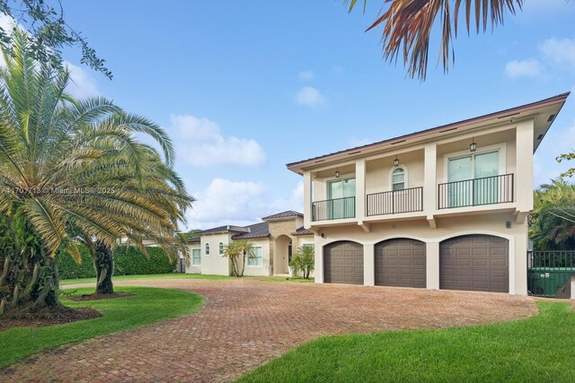 view of front facade featuring a balcony and a garage