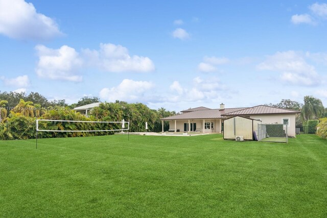 view of front of property featuring a balcony, a front lawn, and a garage