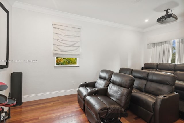 home theater with wood-type flooring and crown molding