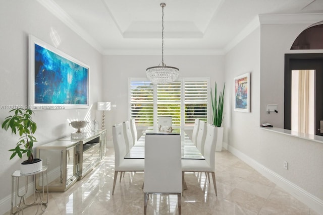 dining area featuring a tray ceiling, crown molding, and an inviting chandelier